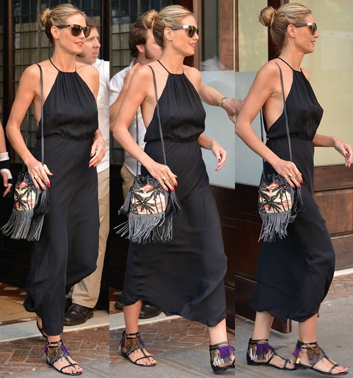 Heidi Klum accessorizes her black Nili Lotan dress with fringed sandals and a matching fringed handbag