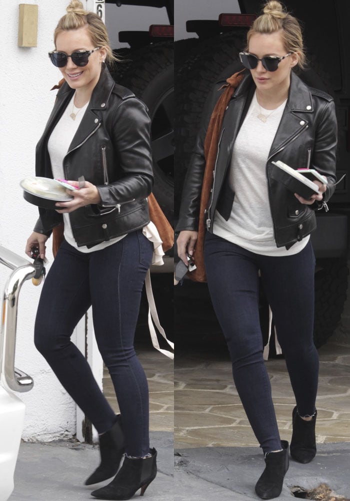 Hilary Duff layers up in jeans and a leather jacket after leaving her gym