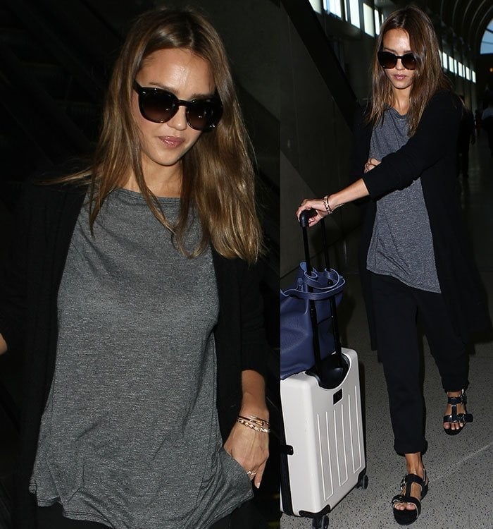 Jessica Alba wears a Michael Stars t-shirt with black pants and a cardigan as she arrives at LAX