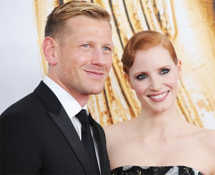 Shoe designer Paul Andrew and actress Jessica Chastain pose for photos