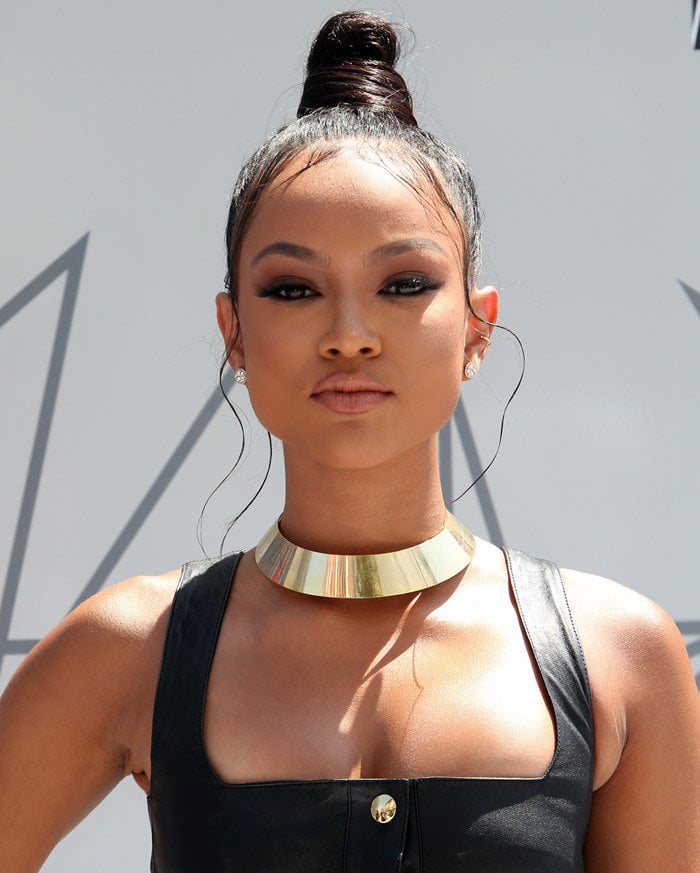 Karrueche Tran came dressed in a skin-tight black leather dress featuring gold buttons down the entire front