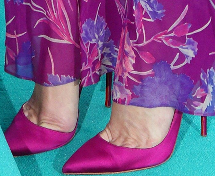 Kate Moss perfectly coordinates her look with Christian Louboutin "Iriza" pumps in a striking fuchsia hue, seamlessly matching her floral maxi dress