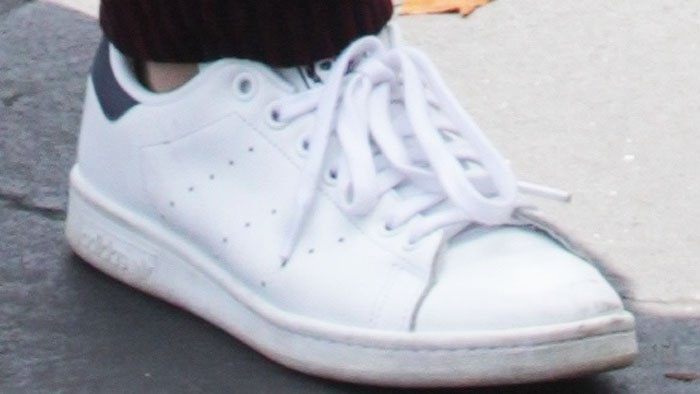 Kendall Jenner's feet in clean white Adidas Stan Smith sneakers