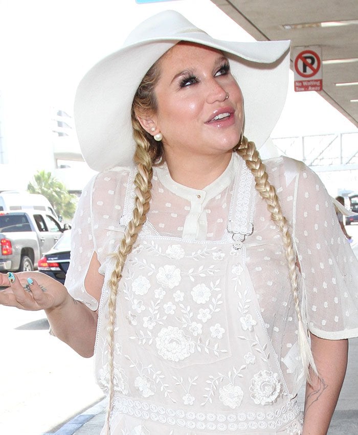 Kesha tops her braided hair with a hat at Los Angeles International Airport