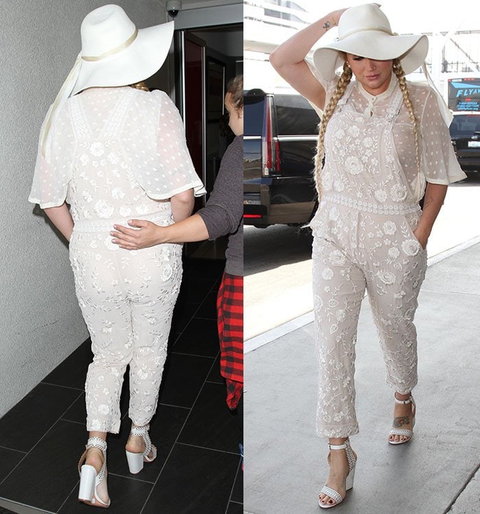 Kesha strolls through the Los Angeles airport in embroidered white overalls and a floppy white hat