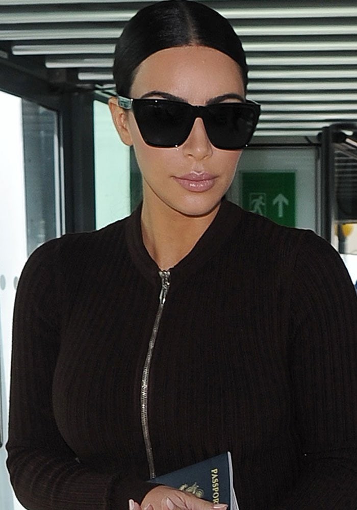 Kim Kardashian Sports Givenchy Sunglasses & Yeezy Boots at Heathrow