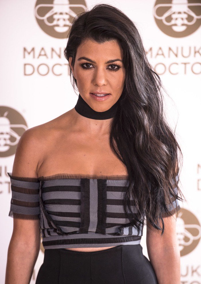 Kourtney Kardashian wears her hair down at a photo call to celebrate her appointment as Global Brand Ambassador for Manuka Doctor