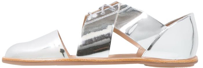 Dramatic cutouts modernize the oxford-inspired profile of a standout flat shaped from burnished, mirror-shine leather