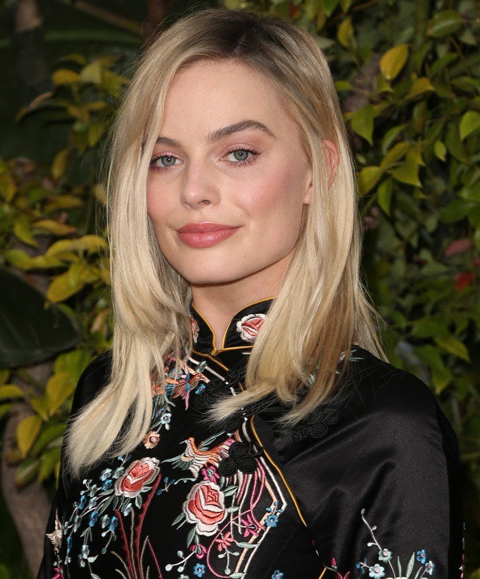 Margot Robbie shows off the embroidered flowers on her black Mandarin-inspired Gucci dress