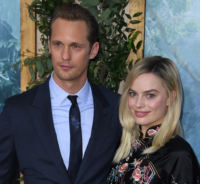 Alexander Skarsgard and Margot Robbie pose for photos on the carpet of the premiere of their latest "Tarzan" movie