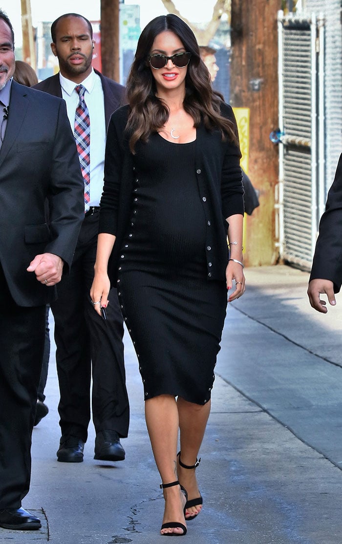 Megan Fox was all smiles as she proudly showed off her baby bump in a fitted black dress by Alexander Wang