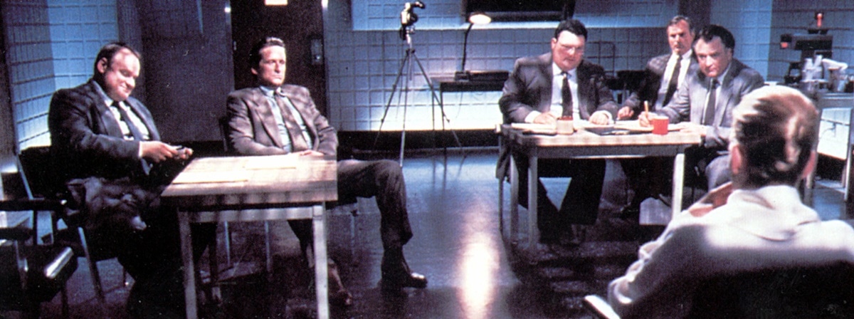 Michael Douglas, George Dzundza, Wayne Knight, Denis Arndt, Chelcie Ross, and Sharon Stone in the Basic Instinct interrogation scene that has had a significant impact on popular culture and the film industry