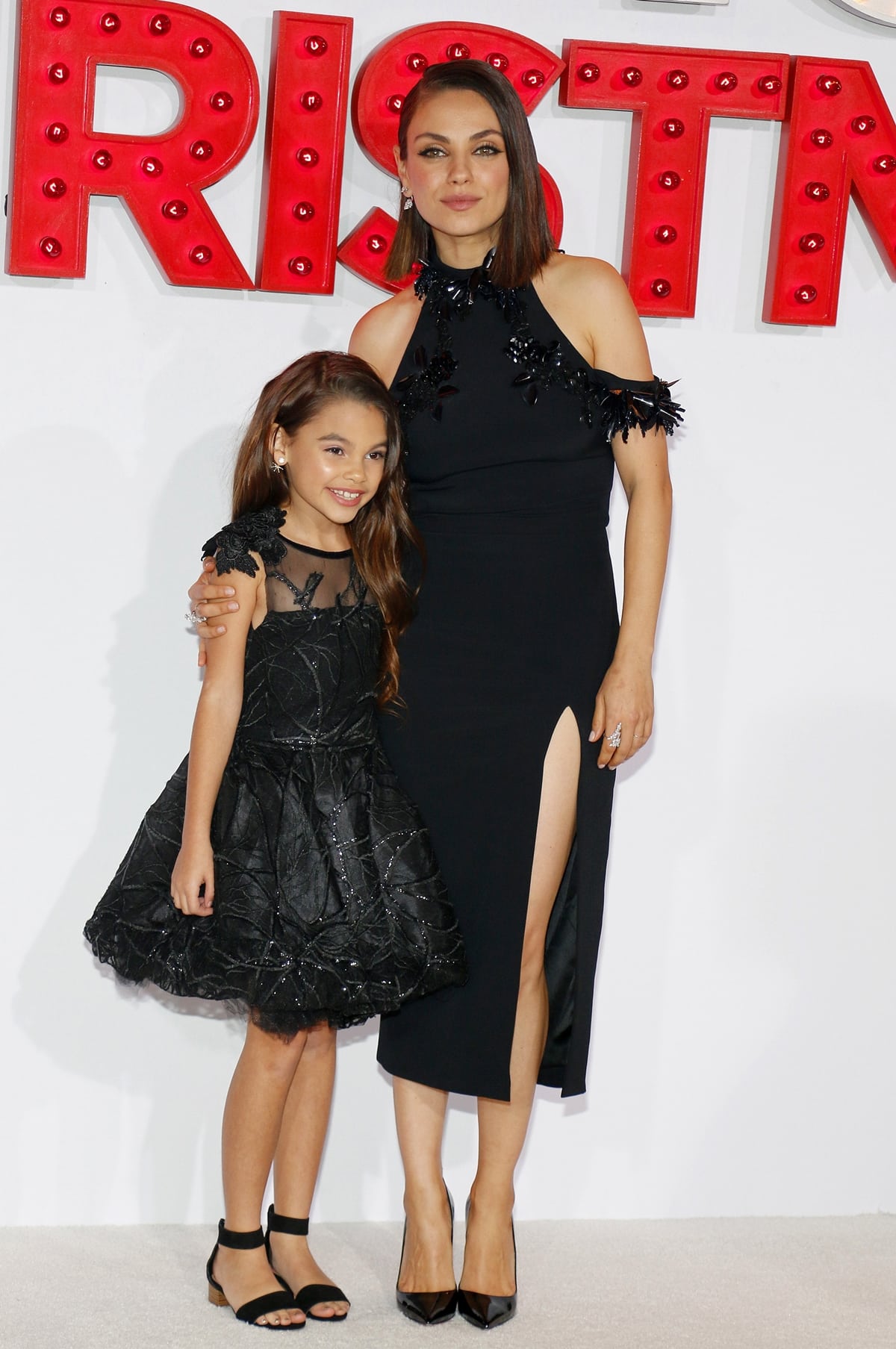 Mila Kunis Mila Kunis poses with young co-star Ariana Greenblatt at the premiere of STX Entertainment's "A Bad Moms Christmas"