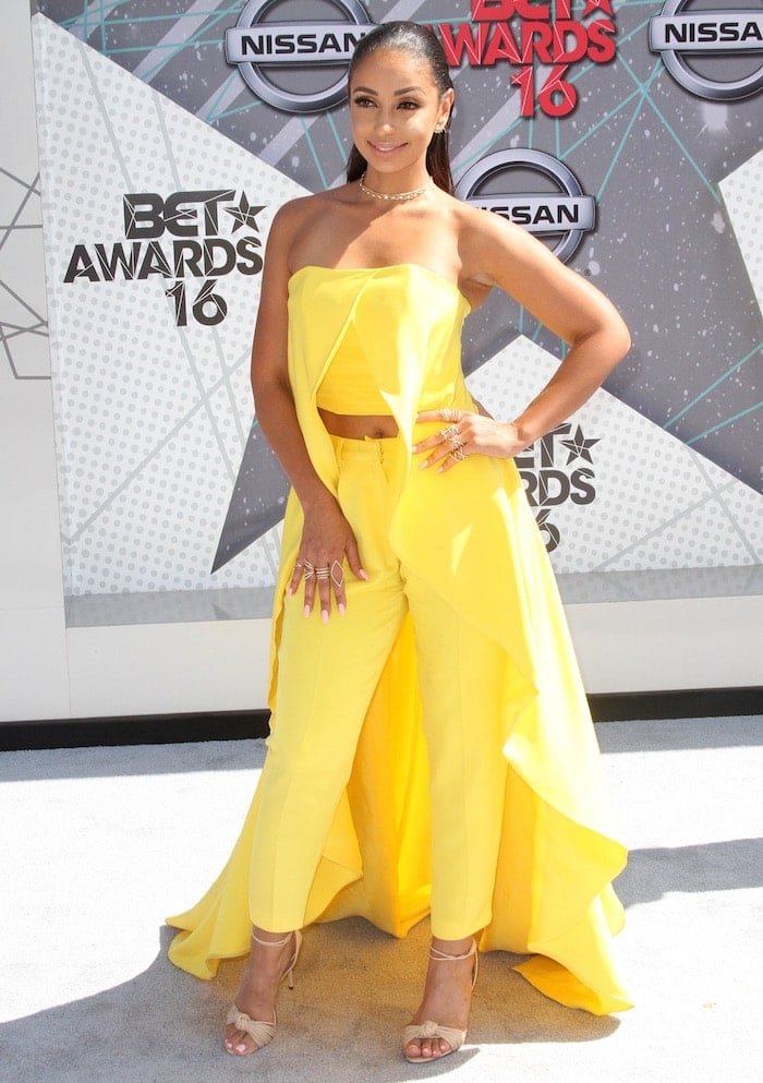 Mya poses on the BET Awards carpet in an unflattering yellow Christian Siriano creation