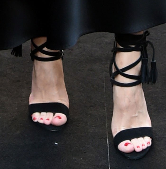 Olivia Palermo's feet in black suede Rebecca Minkoff sandals