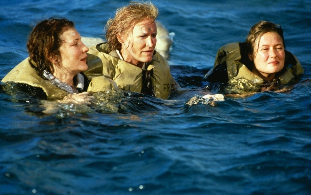 Cate Blanchett as Susan Macarthy, Glenn Close as Adrienne Pargiter, and Jennifer Ehle as Rosemary Leighton-Jones in the water after their boat is bombed by Japanese fighter planes in Paradise Road