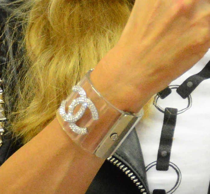 Paris Hilton adds a touch of glam to her outfit with a sparkling Chanel cuff