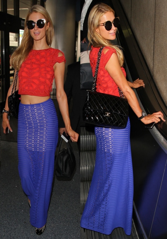 Paris Hilton flashes her toned abs in a high-waisted blue maxi skirt from Revolve