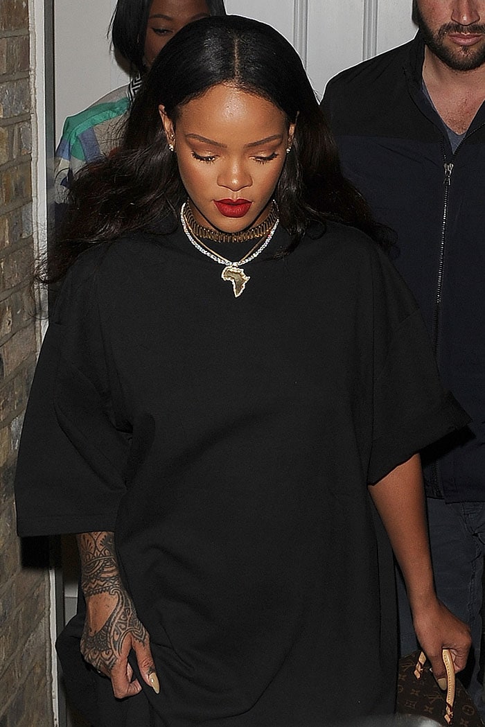 Rihanna accessorizes with an African pendant necklace