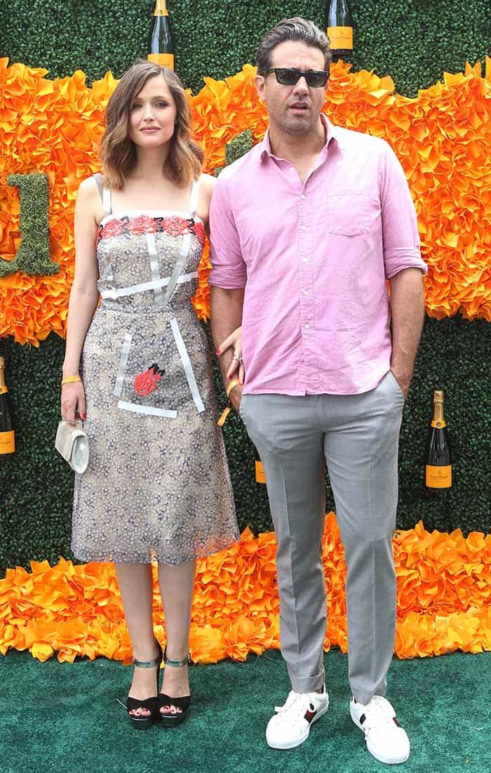 Rose Byrne stuns in a floral Christopher Kane dress, elevating her look with black platform Prada sandals, while Bobby Cannavale keeps it casual in white Gucci Ace sneakers