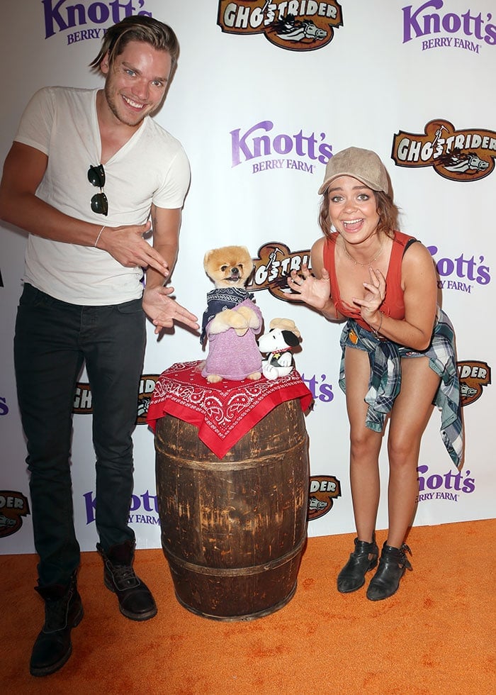 Dominic Sherwood and Sarah Hyland pose for photos with Jiff the Pomeranian at Knott's Berry Farm