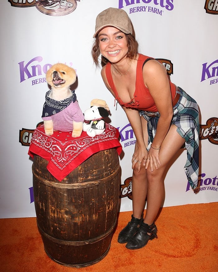 Sarah Hyland flashes her cleavage and legs in a plunging tank top and short shorts