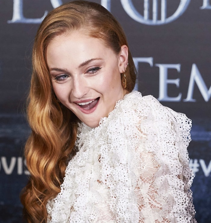 Sophie Turner wears her red hair down and curled at a "Game of Thrones" fan event