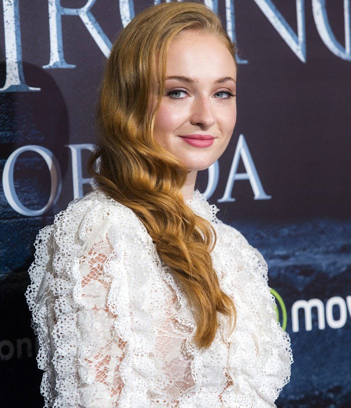Sophie Turner wears a white lace dress from Louis Vuitton to a "Game of Thrones" fan event