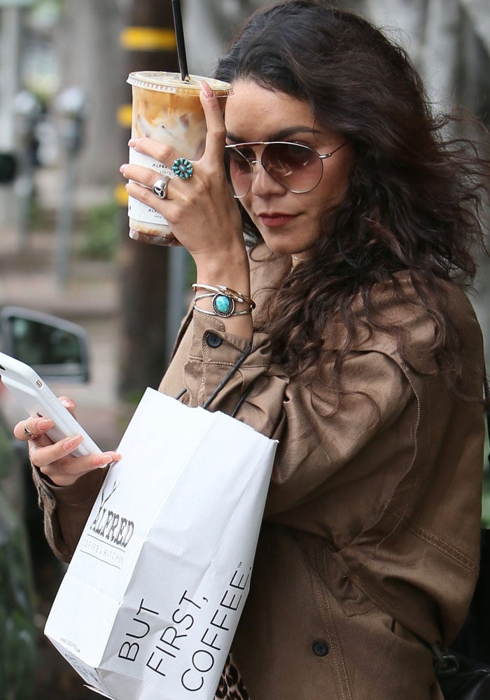 A camera-shy Vanessa Hudgens leaves Alfred Cafe with a coffee as she heads to a hair appointment