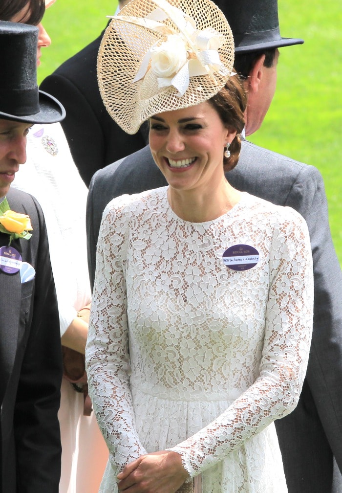 Kate Middleton wears a name tag on her white lace Dolce & Gabbana dress