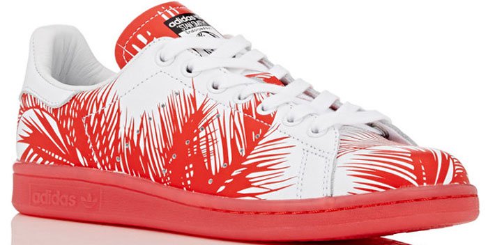 The shoe’s traditional white leather construction is accented with red palm leaves throughout the upper, while the midsole is contrasted with an icy red hue
