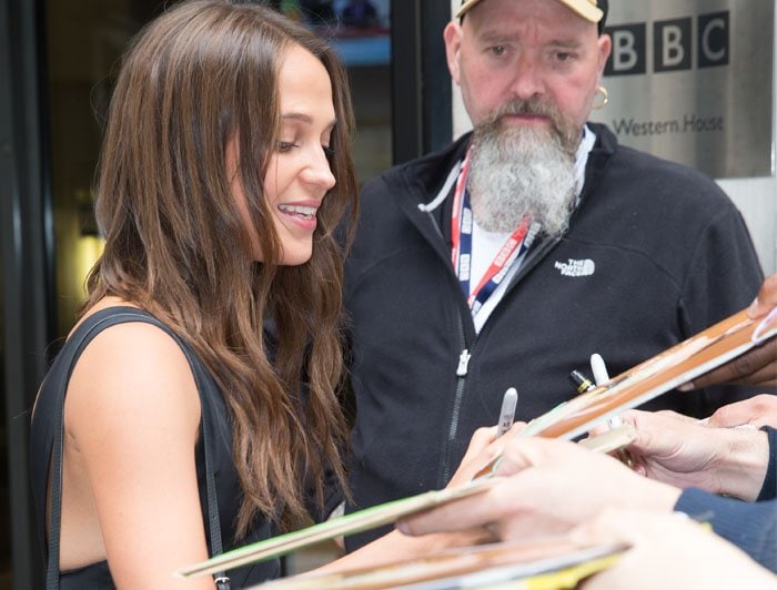 Alicia Vikander signs autographs as she arrives at the BBC Radio studios in London