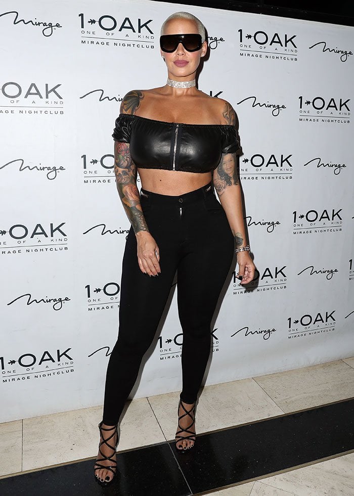 Amber Rose shows off her tattoos in a leather Alexander Wang crop top