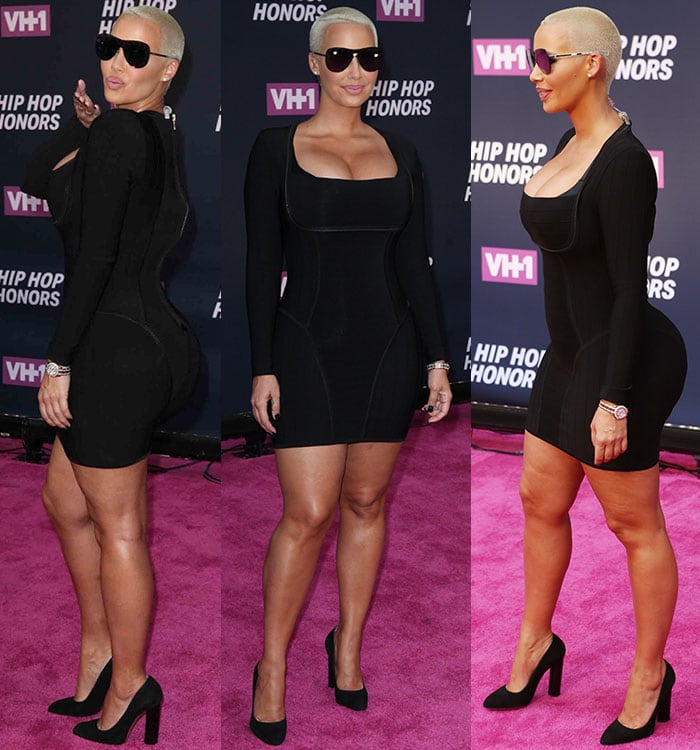 Amber Rose shows off her ample assets in a little black dress