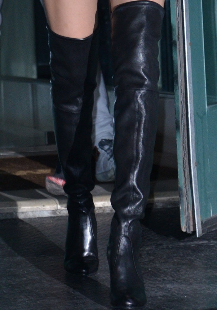 Bella Hadid wears a pair of black leather over-the-knee Stuart Weitzman boots out to dinner