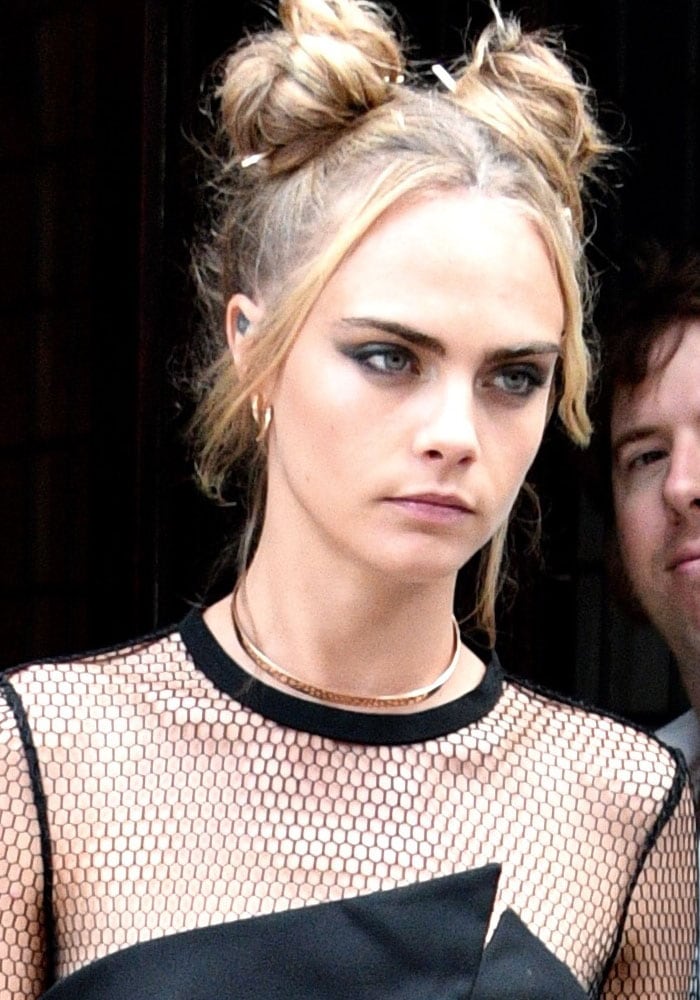 Cara Delevingne's hair was styled in two charmingly messy buns on top of her head, evoking a nostalgic vibe reminiscent of Baby Spice, and even a hint of Harley Quinn's iconic look