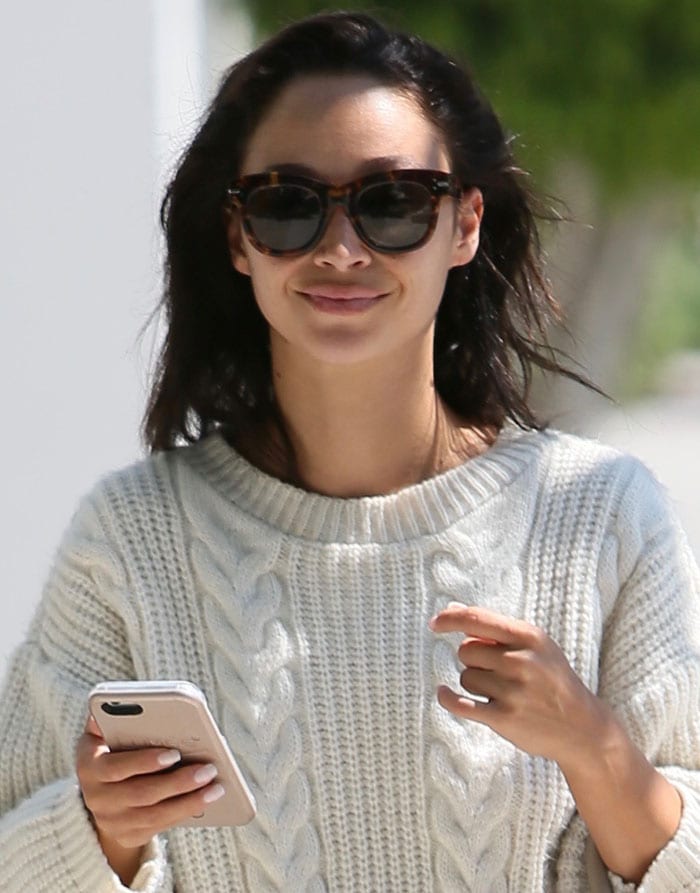 Embracing simplicity, Cara Santana goes for a natural look with messy hair and minimal makeup, accentuated by stylish sunglasses