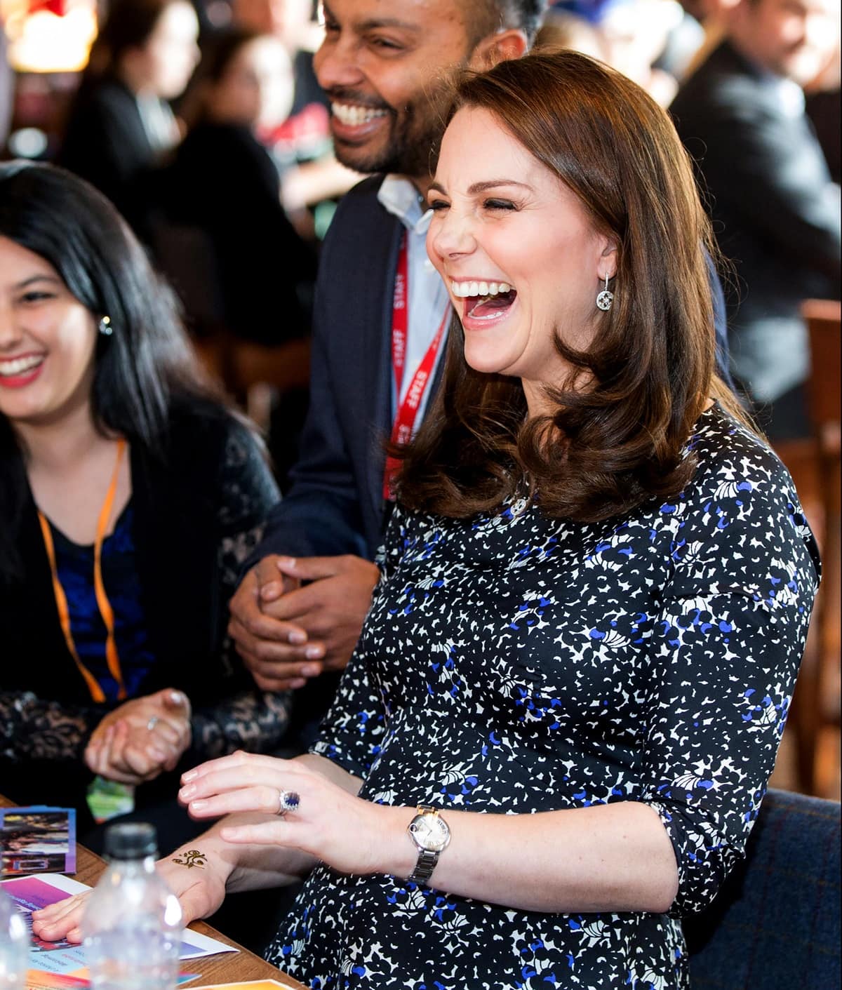 Catherine, Duchess of Cambridge, wearing a Seraphine Phaedra maternity dress, gets a henna tattoo