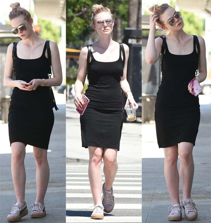 Elle Fanning pairs a casual black dress with a topknot and a leather backpack