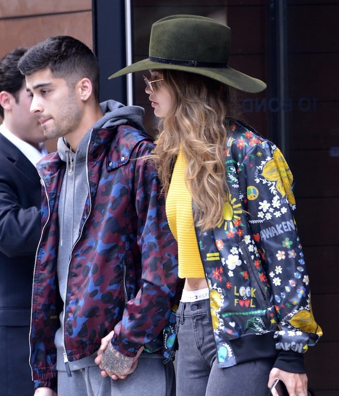 Gigi Hadid goes incognito by wearing sunglasses and topping her hair with a hat while leaving her apartment with on-again off-again boyfriend Zayn Malik