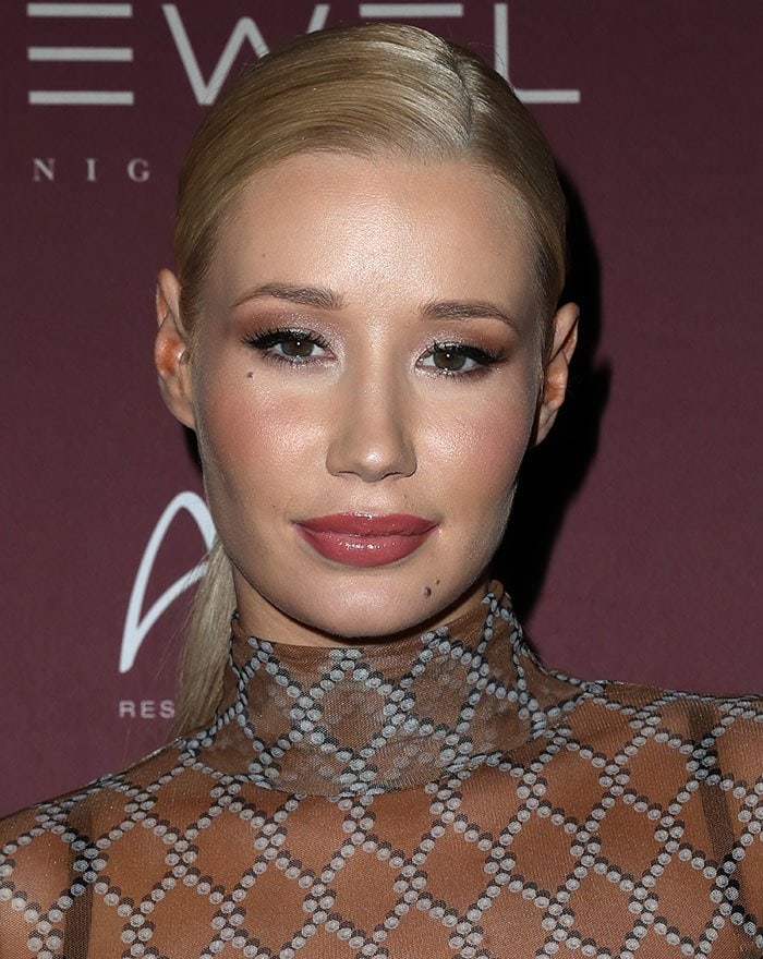 Iggy Azalea side parts her blonde hair during a night out at Jewel Nightclub inside Aria