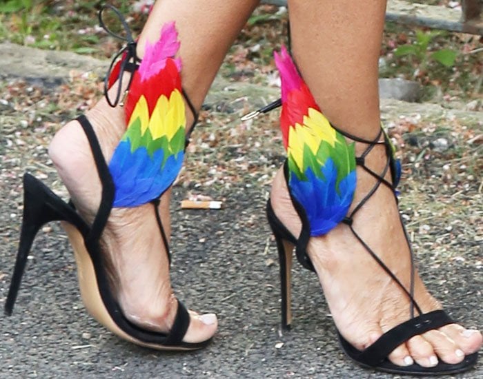 Jackie St Clair's feet in colorful feathered Ferragamo x Edgardo Osorio sandals