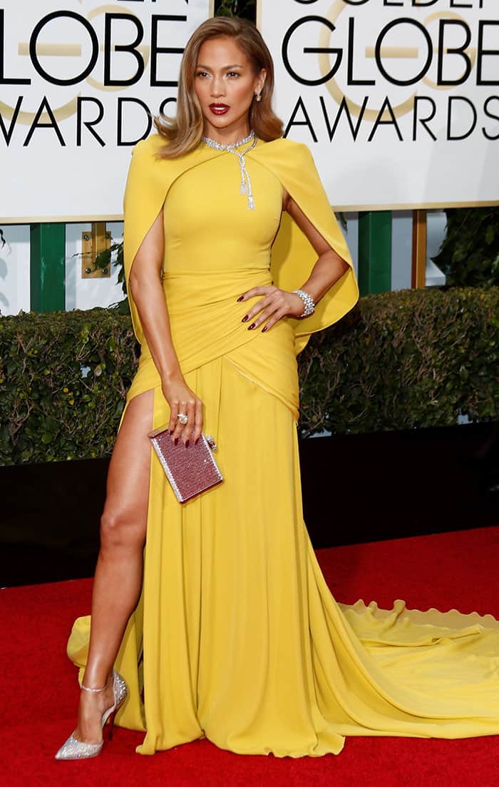 Jennifer Lopez in a yellow cape-sleeved gown from Giambattista Valli