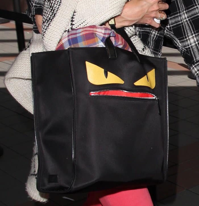 Katie Holmes carries a black Fendi ‘Monster Creature’ tote, featuring signature yellow eyes and a red zippered mouth for a bold, whimsical statement