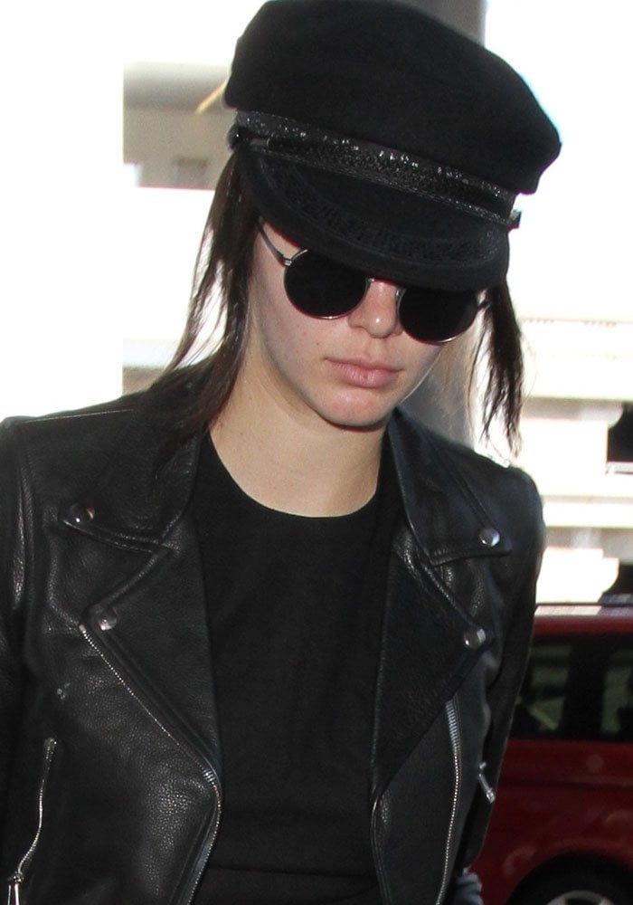 Kendall Jenner, without a trace of makeup in a Saint Laurent wool hat, at Los Angeles International Airport (LAX)