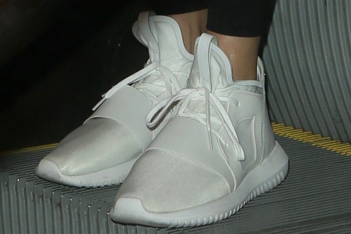 Kendall Jenner wearing white adidas Tubular Defiant premium tech sneakers