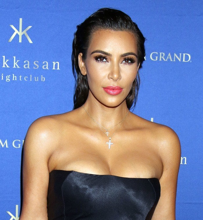 Kim Kardashian in a strapless silky dress that revealed her ample cleavage