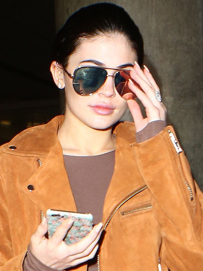 Kylie Jenner wears her hair back as she arrives at Los Angeles International Airport following a trip to Budapest for boyfriend-slash-rumored-fiancé Tyga's concert