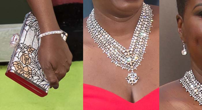 Leslie Jones added bling with a Danni Jo necklace, Chris Aire earrings, and metallic Judith Leiber clutch