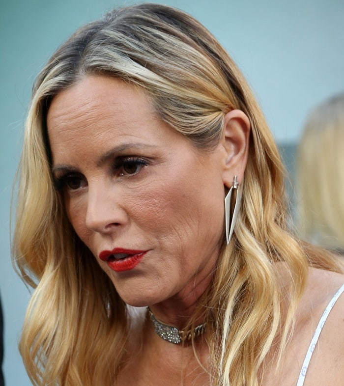 Maria Bello's gray roots peek out from beneath her blonde hair